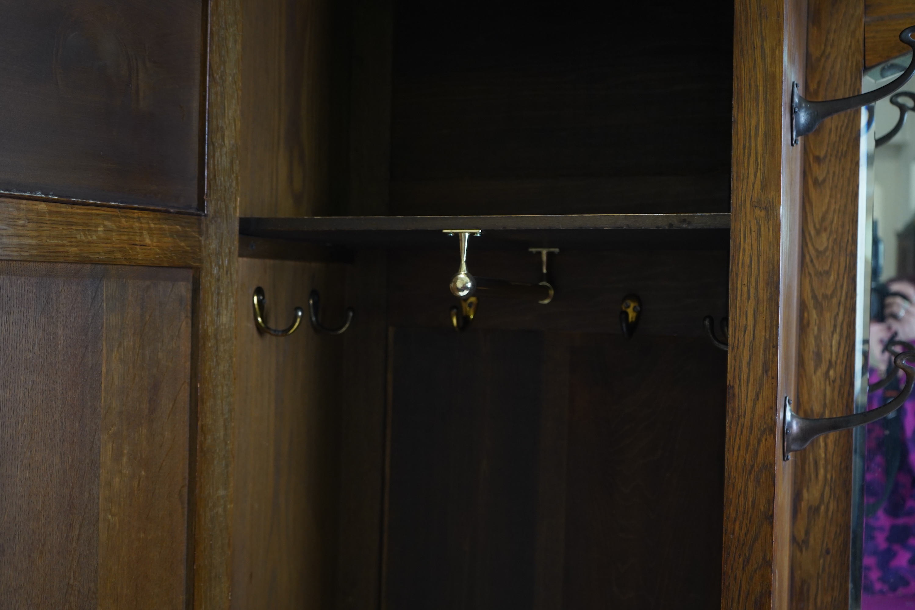 Manner of Liberty & Co: An Arts and Crafts embossed copper mounted oak hall cupboard